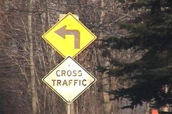 Cross traffic textual warning sign