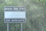Avoid the fine: use headlights (black sign, white text)