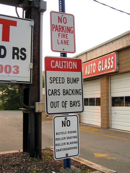 Caution; Speed bump cars backing out of bays