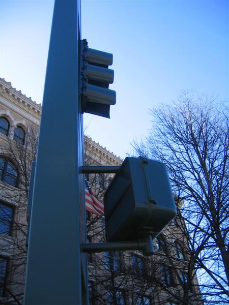 Pedestrian signal head on bus signal post