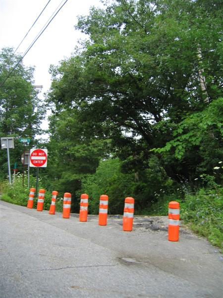 Plastic crash guards and Do Not Enter sign on closed road