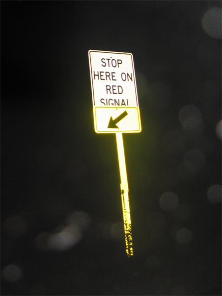 Stop here on red signal (with yellow arrow and sign post reflector)