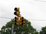 Left-turn signal lights on top of traffic light